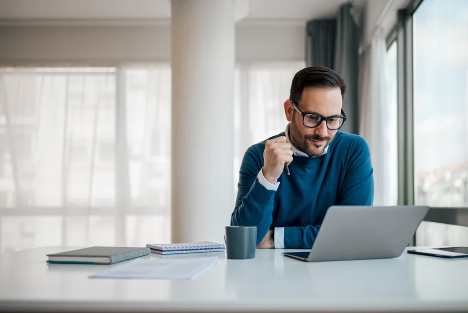 Entrepreneur on the telephone beside a laptop