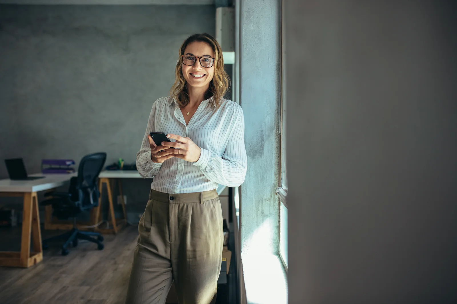 Entrepreneur with a telephone by a window